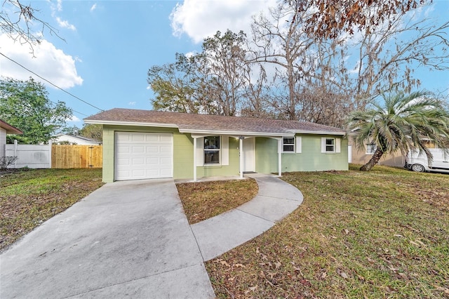 ranch-style house with a garage and a front lawn