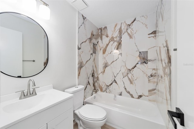 full bathroom featuring tiled shower / bath, vanity, and toilet