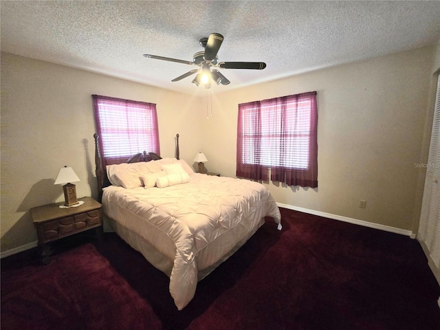 carpeted bedroom featuring ceiling fan and a textured ceiling