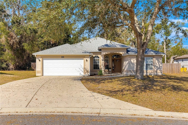 view of front of property with a garage and a front yard