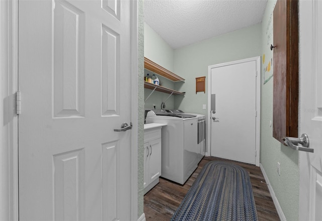 laundry room featuring dark hardwood / wood-style flooring, a textured ceiling, and independent washer and dryer