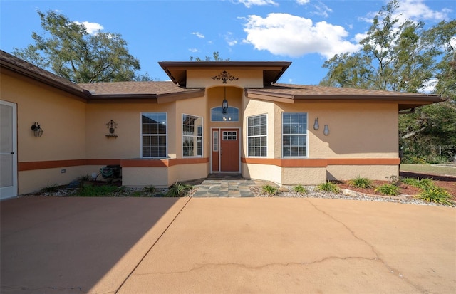 property entrance featuring a patio area