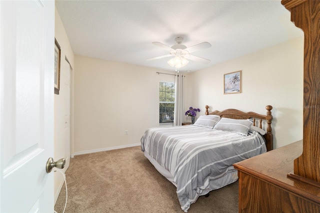 bedroom with ceiling fan and light carpet