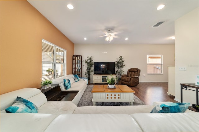 living room with hardwood / wood-style flooring, ceiling fan, and a wealth of natural light