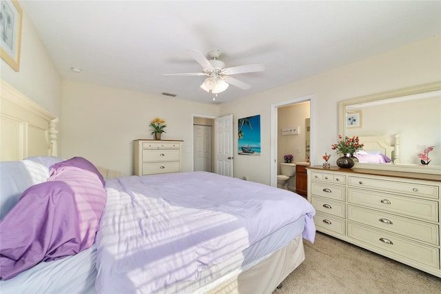 carpeted bedroom featuring connected bathroom, ceiling fan, and a closet