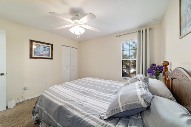 bedroom with ceiling fan, carpet flooring, and a closet