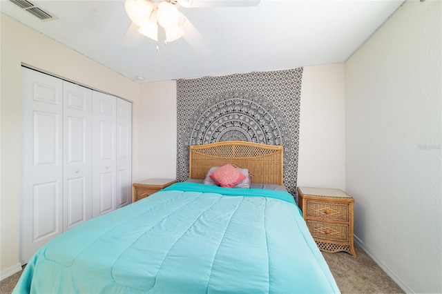 carpeted bedroom with a closet and ceiling fan