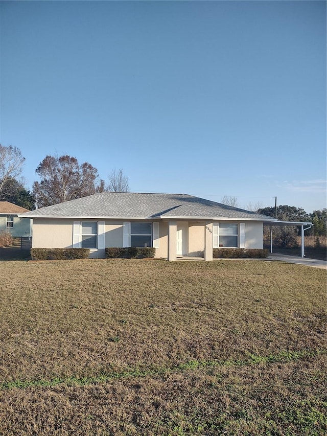 ranch-style home featuring a front yard