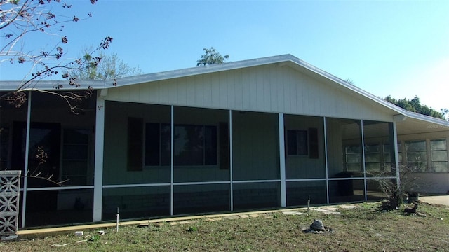 view of home's exterior with a sunroom