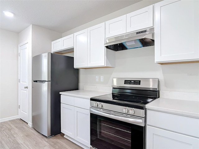 kitchen with a textured ceiling, light hardwood / wood-style flooring, stainless steel appliances, and white cabinets