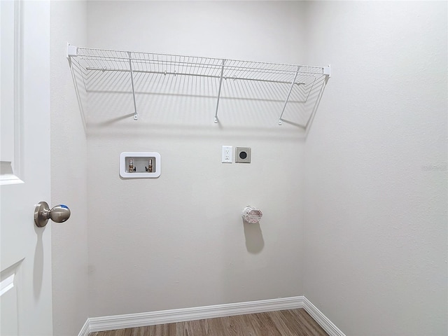 washroom with hookup for a washing machine, hardwood / wood-style floors, and electric dryer hookup