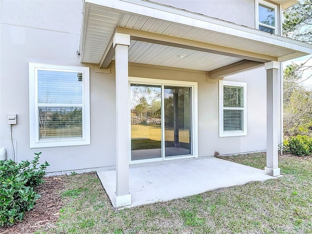 view of exterior entry featuring a patio area