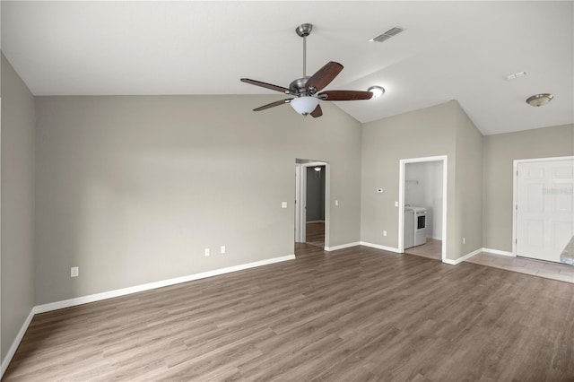 interior space featuring lofted ceiling, washer / dryer, wood-type flooring, and ceiling fan