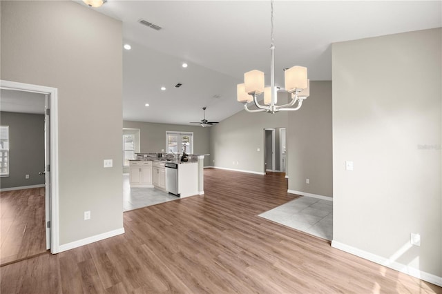 interior space featuring ceiling fan with notable chandelier, light hardwood / wood-style floors, white cabinets, decorative light fixtures, and stainless steel dishwasher