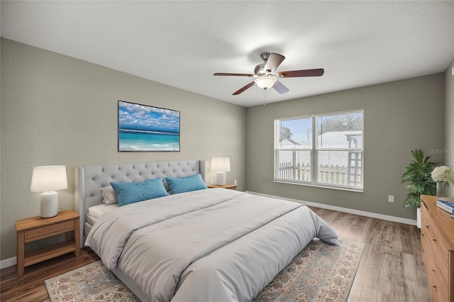 bedroom with hardwood / wood-style flooring and ceiling fan