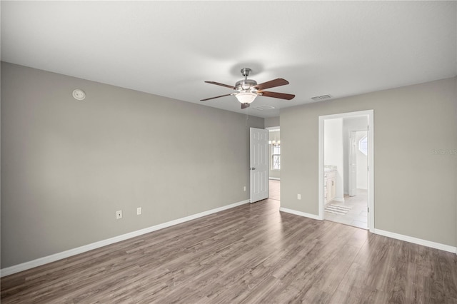 spare room featuring ceiling fan and light wood-type flooring