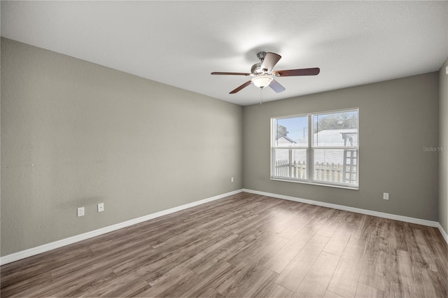 empty room featuring hardwood / wood-style flooring and ceiling fan