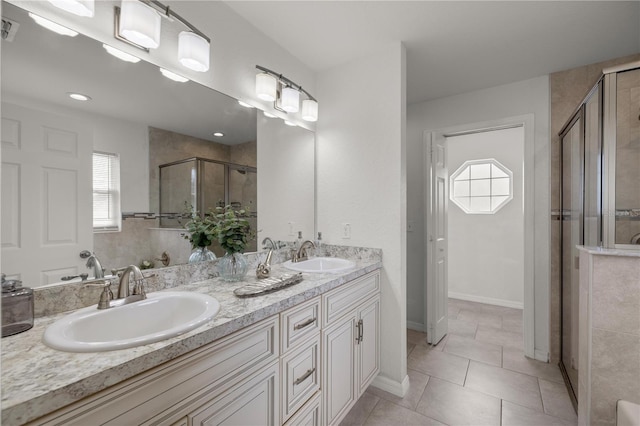 bathroom featuring tile patterned flooring, vanity, and a shower with shower door