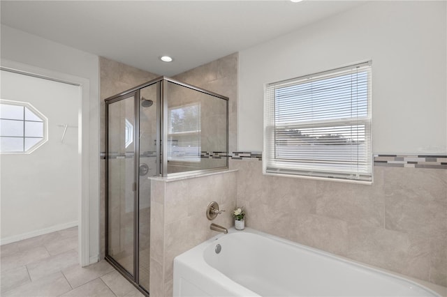 bathroom with shower with separate bathtub and tile patterned flooring