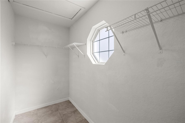 spacious closet featuring tile patterned flooring