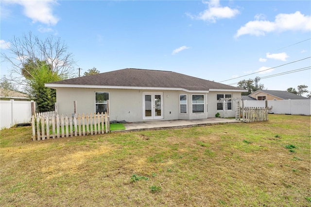 back of house with a lawn and a patio area