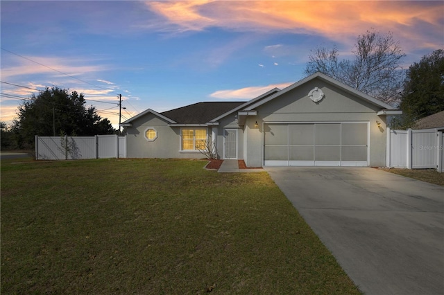 ranch-style home with a garage and a lawn