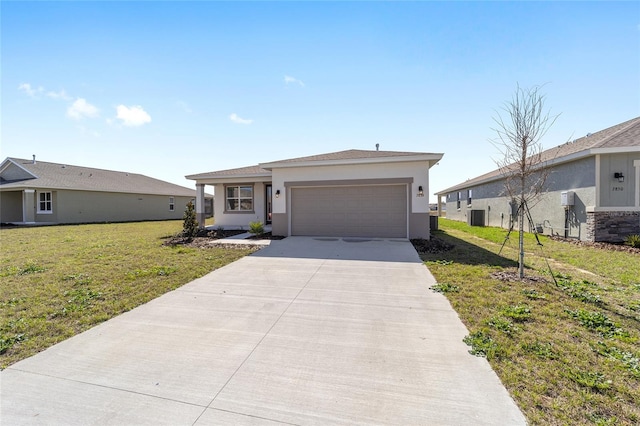 single story home with central AC, a garage, and a front yard