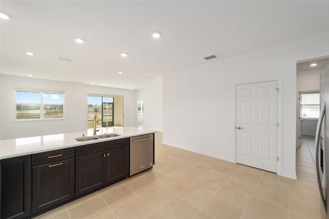 kitchen with dishwasher, sink, and light tile patterned floors