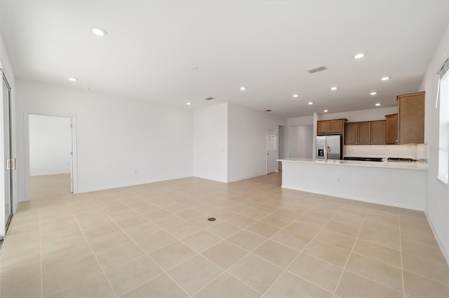 unfurnished living room featuring light tile patterned flooring