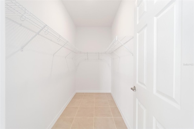 spacious closet with light tile patterned flooring