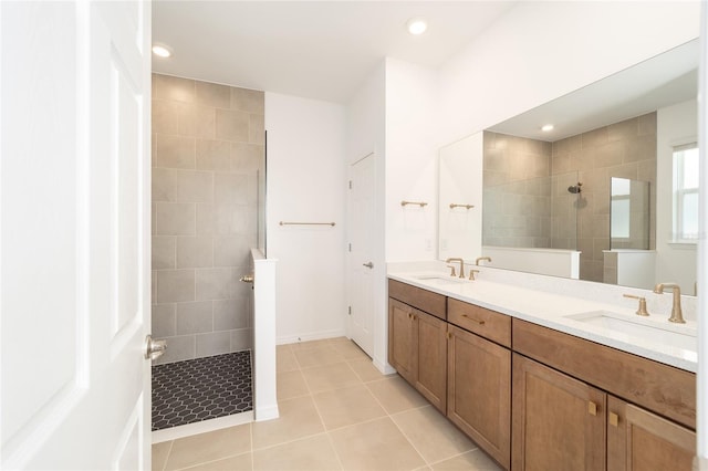 bathroom with vanity, tile patterned floors, and tiled shower