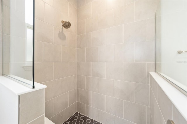 bathroom with a tile shower