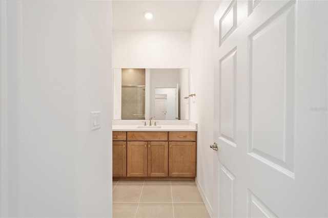 bathroom featuring vanity, tile patterned floors, and walk in shower