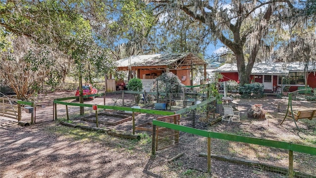 view of yard featuring a vegetable garden and an outdoor structure