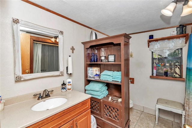 bathroom with toilet, a textured ceiling, vanity, and crown molding