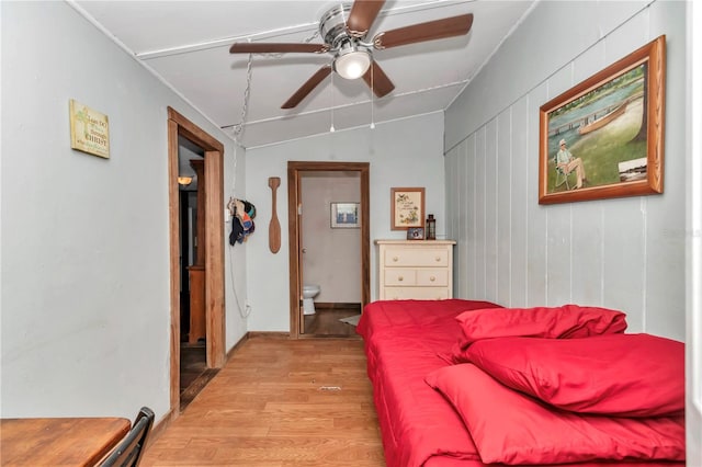 bedroom featuring light wood-style floors, ceiling fan, and vaulted ceiling