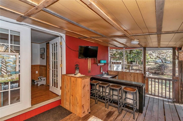 exterior space featuring wood ceiling and indoor wet bar