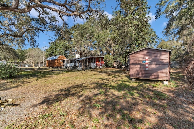 view of yard with a storage shed and an outdoor structure