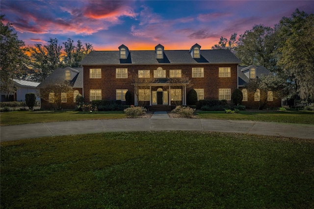 colonial home featuring a yard