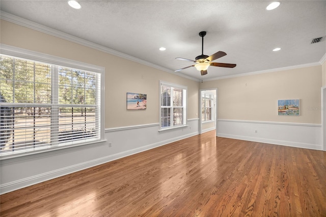 spare room featuring hardwood / wood-style floors, crown molding, a textured ceiling, and ceiling fan