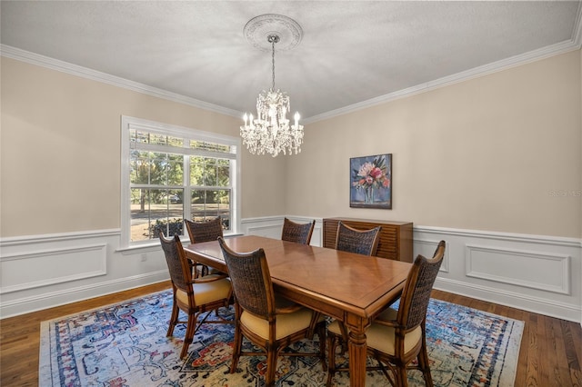 dining room featuring ornamental molding, dark hardwood / wood-style flooring, and a notable chandelier