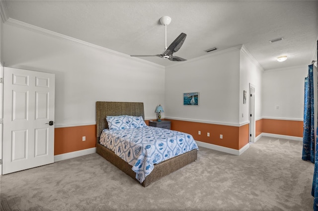 carpeted bedroom featuring ceiling fan, ornamental molding, and a textured ceiling