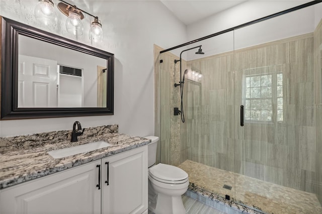 bathroom featuring vanity, toilet, and walk in shower