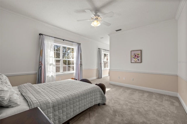 carpeted bedroom featuring ornamental molding and ceiling fan