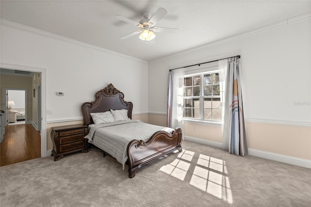 carpeted bedroom featuring ceiling fan and ornamental molding