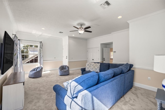 carpeted living room with crown molding and ceiling fan