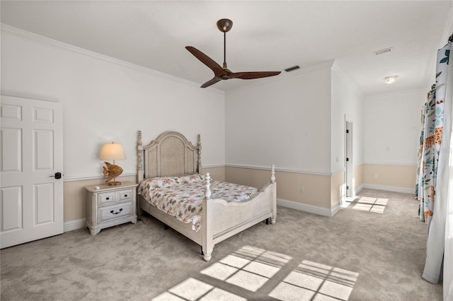 carpeted bedroom featuring crown molding and ceiling fan