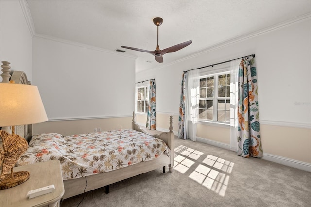 bedroom with crown molding, light colored carpet, and ceiling fan