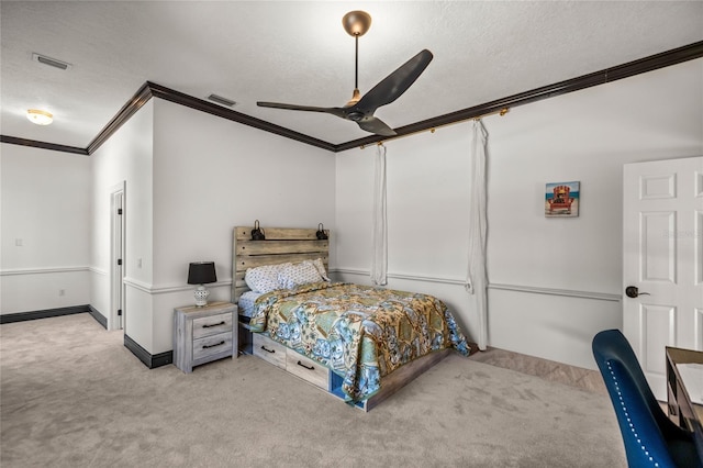 bedroom with crown molding, ceiling fan, light carpet, and a textured ceiling