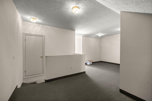 carpeted spare room featuring a textured ceiling